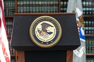 Seal of Justice Department seen during press conference in 2022. (Lev Radin/Pacific Press via Zuma Press Wire/TNS)